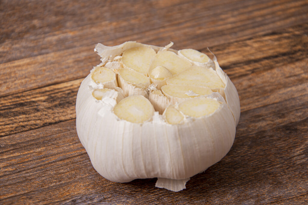 Cut the top of the garlic off to expose the garlic cloves.