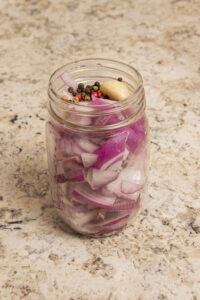 Chop red onions up and place in a jar 