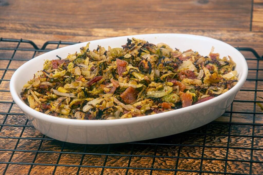 Shaved brussels sprouts and bacon plated.